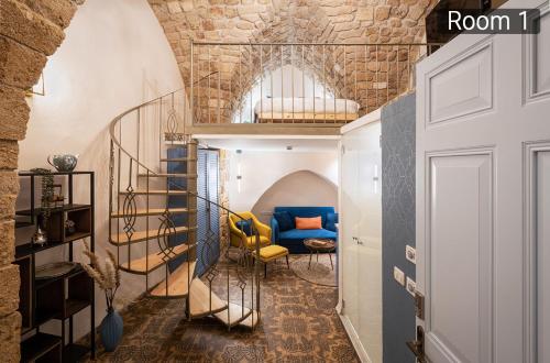 a room with a staircase and a blue couch at Villa Sera in ‘Akko