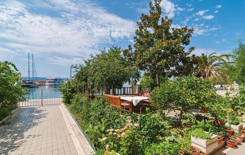 a patio with a table and trees and a body of water at Apartment Marija in Krilo
