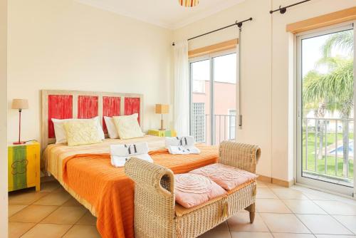 a bedroom with a large bed and a balcony at Old Village & Prestige in Vilamoura