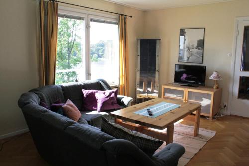 a living room with a couch and a coffee table at Liljeholmen Herrgård Hostel in Rimforsa