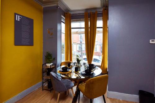 a dining room with a table and chairs and a window at Home away from Home in Beeston