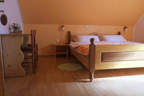 a bedroom with a bed and a table and a chair at Farm Pri Flandru in Cerkno