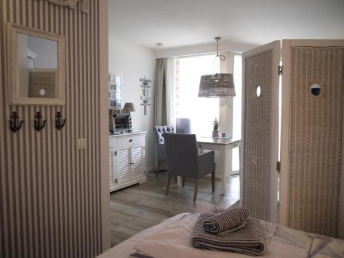a room with a kitchen with a table and a desk at Strandperle 5 in Scharbeutz
