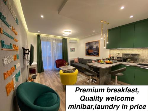 a kitchen and living room with green cabinets and a green chair at BudapestStyle Superior Family Apartman, Private Parking, Breakfast in Budapest
