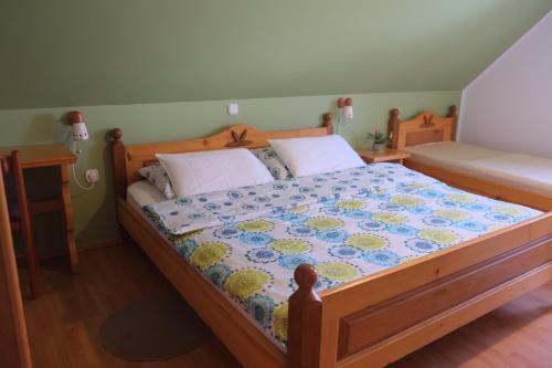 a bedroom with a bed with a quilt on it at Farm Pri Flandru in Cerkno