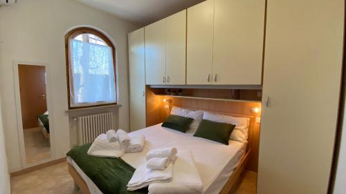 a bedroom with a bed with towels on it at House Dogana in Peschiera del Garda