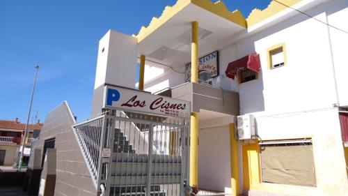 a white building with a sign that reads la couronne at Pension Los Cisnes in Puerto de Mazarrón