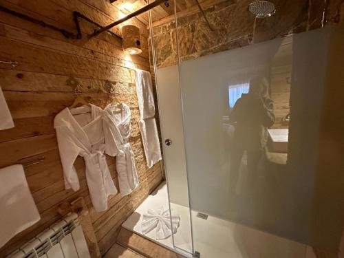 a person taking a picture of a bathroom with a mirror at Hotel Xaluca Spa Aguelmame Sidi Ali in Aguelman