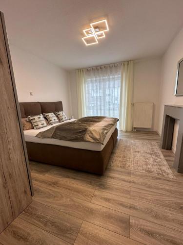 a bedroom with a large bed and a window at Zum Sternberg in Münsingen