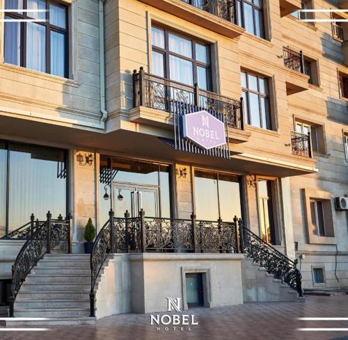 a building with stairs and a sign on it at NOBEL Hotel in Baku