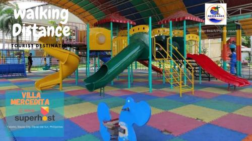 a playground with a slide in a building at Beach Resorts walking distance to the Town House in Davao City