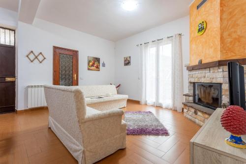 a living room with a chair and a fireplace at Casa splendida in Monreale