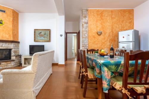 a dining room with a table and a fireplace at Casa splendida in Monreale