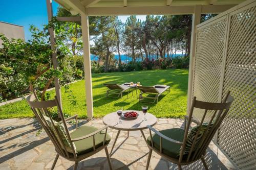 a patio with two chairs and a table and a table and chairs at Seashell Luxury Residence - Studio 1 in Lixouri