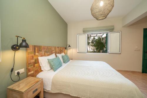 a bedroom with a large bed and a window at Seashell Luxury Residence - Studio 1 in Lixouri