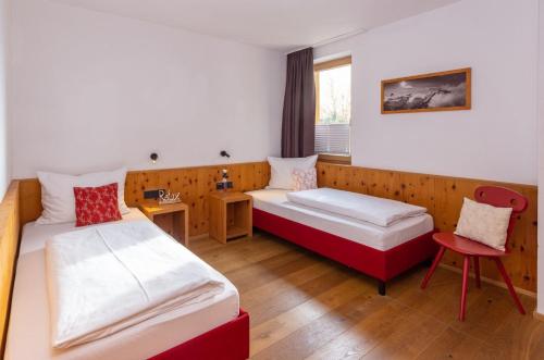 a hotel room with two beds and a table at Hapimag Ferienwohnungen Zell am See in Zell am See