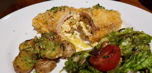 a white plate of food with vegetables and meat at Stargate Villa Pintu Bintang in Pawenang