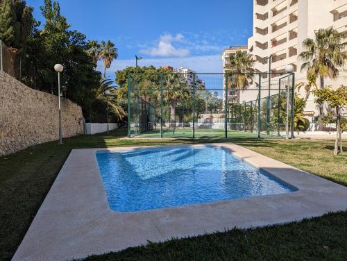 a swimming pool in the middle of a yard at Apartment Mar Augusta in Calpe