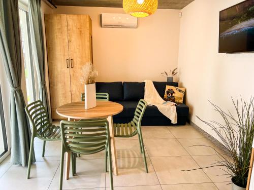 a living room with a table and chairs and a couch at LABA Wieleń in Wielen Zaobrzanski