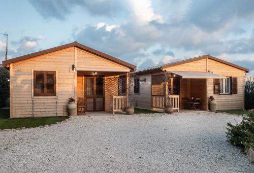 a home with a patio and a house at Casa Vacanze La Fenice - Casa Atlantica in Cava dʼAliga