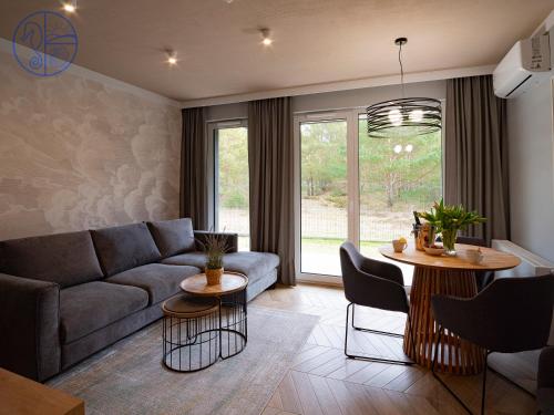 un soggiorno con divano e tavolo di Apartament na wydmie - Porto Łeba a Łeba