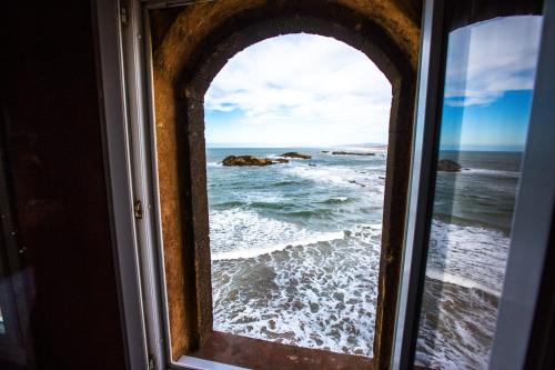 an ocean view from a window of the ocean at Riad Mimouna in Essaouira