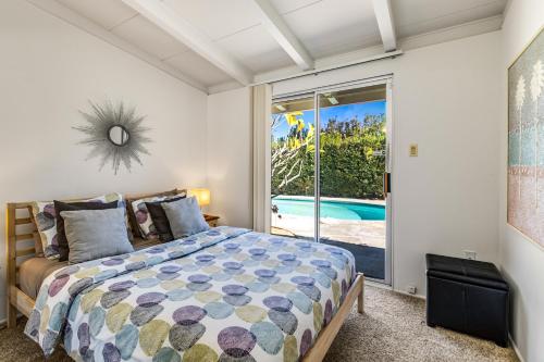 a bedroom with a bed and a view of a pool at Mirage Cove in Rancho Mirage