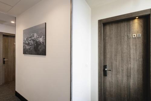 a door in a hallway with a picture on the wall at Best Western Hotel dei Mille in Naples