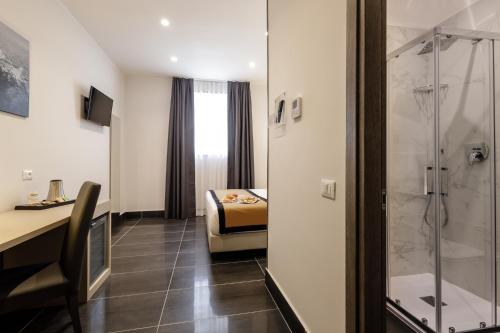 a hotel room with a shower and a bedroom at Best Western Hotel dei Mille in Naples