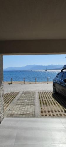 a car parked in a garage next to the beach at By The Sea - Paleros in Paleros