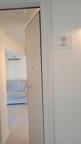 a door leading to a room with a bed at By The Sea - Paleros in Paleros
