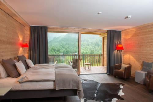 a bedroom with a large bed and a balcony at Boutique Hotel Locanda Fior di Campo in Campo