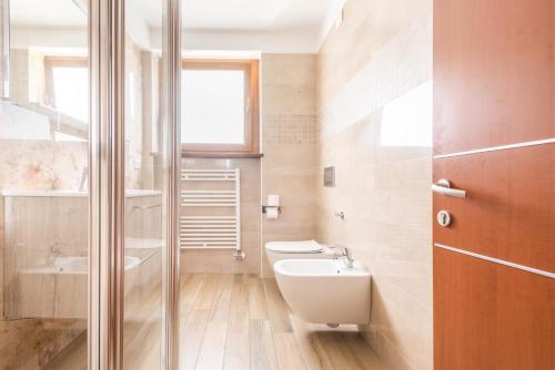 a bathroom with a toilet and a sink at CROSINA HOLIDAY - Casa Lucia in Ledro