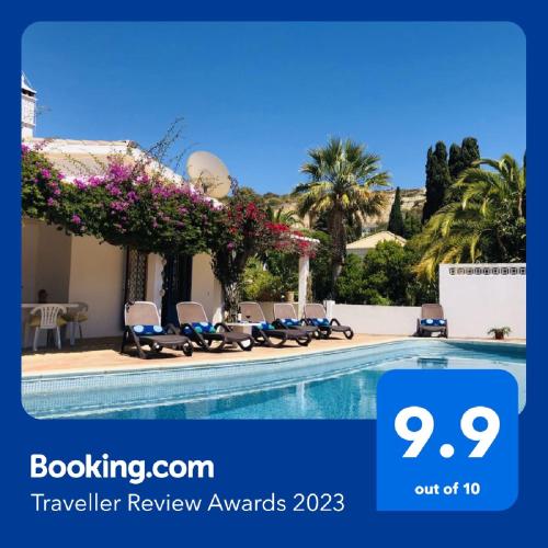 a hotel with a swimming pool with flowers on it at Charming Villa with Heated Pool near Sandy Beach, Hiking, Golf and Wineries in Luz