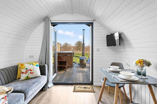 a living room with a couch and a table at Kingston Black, Apple Tree Glamping, Nr Wells in Wells