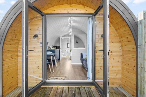 an arched room with a glass door in a house at Kingston Black, Apple Tree Glamping, Nr Wells in Wells