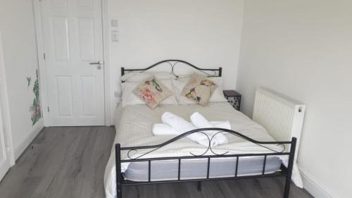 a bedroom with a bed with white sheets and pillows at Woodlands Bellevue Bed & Breakfast in New Quay