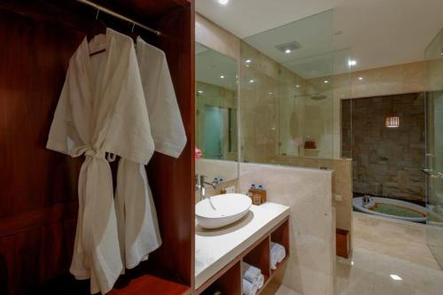 a bathroom with a sink and a shower and a tub at Sanata Luxury Villa in Canggu
