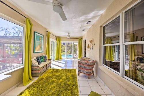 a living room with yellow curtains and a rug at House with Heated Pool and Grill - Walk to Beach! in Marco Island