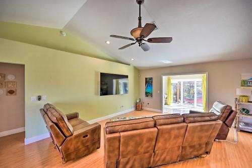 a living room with a couch and a ceiling fan at House with Heated Pool and Grill - Walk to Beach! in Marco Island