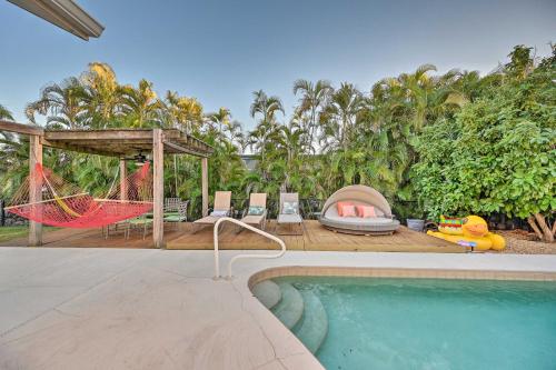 a resort with a hammock and a swimming pool at House with Heated Pool and Grill - Walk to Beach! in Marco Island