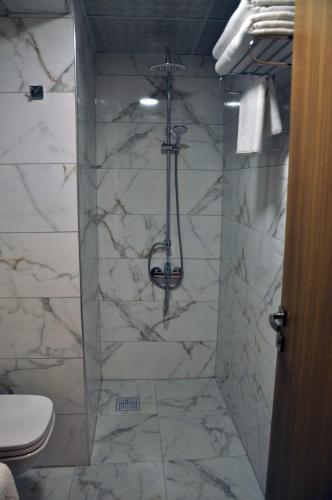 a bathroom with a shower with a toilet at ERZURUM DAMAK GRUP in Erzurum