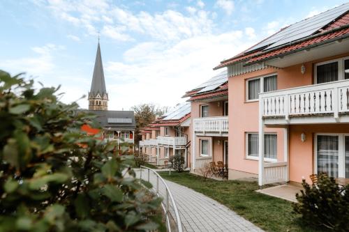 a street in a town with a church at Hotelpark Bodetal mit Ferienwohnungen in Thale