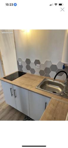 a kitchen with a sink and a counter top at Appartement centre ville in LʼAigle