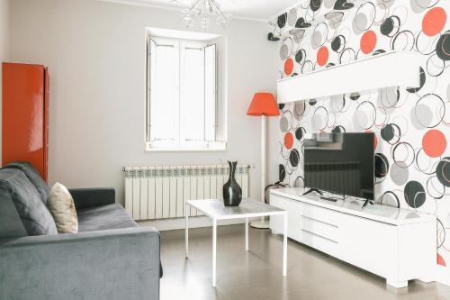 a living room with a couch and a table at Apartamentos Villa Fresnedo in Solares