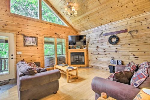 a living room with two couches and a fireplace at Cabin with Hot Tub and Deck about 12 Mi to Pigeon Forge! in Sevierville