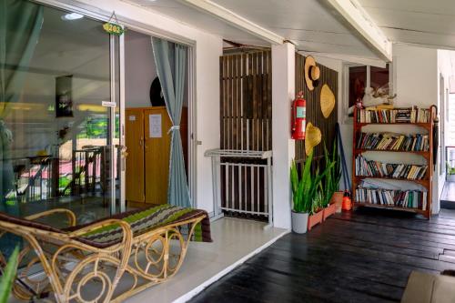 a living room with a bench and a book shelf at JOP in Ko Chang