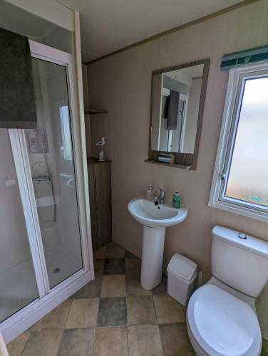 a bathroom with a toilet and a sink and a shower at Haven Holiday Home Littlesea Sleeps 6 in Weymouth