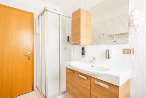 a bathroom with a sink and a shower at CROSINA HOLIDAY - Casa Lucia in Ledro