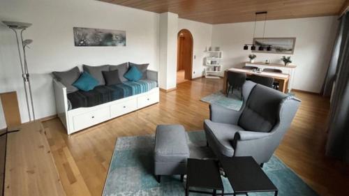 a living room with a couch and a chair at Ferienwohnung Kessler in Ommersheim
